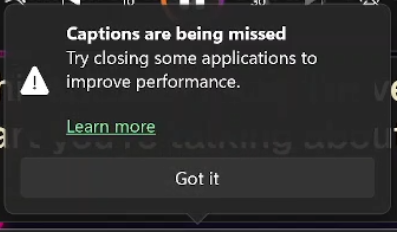 Windows Live Captions warning: 'Captions are being missed. Try closing some applications to improve performance.' with a Learn more link and a Got it button.